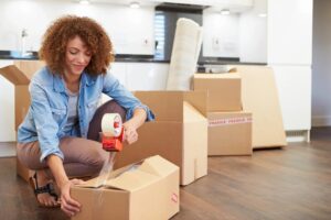 A woman packs boxes for a house move 