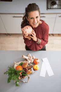 A woman in a red shirt stands at a kitchen countertop smiling as she deposits money in her piggy bank. she has groceries and grocery receipts nearby.